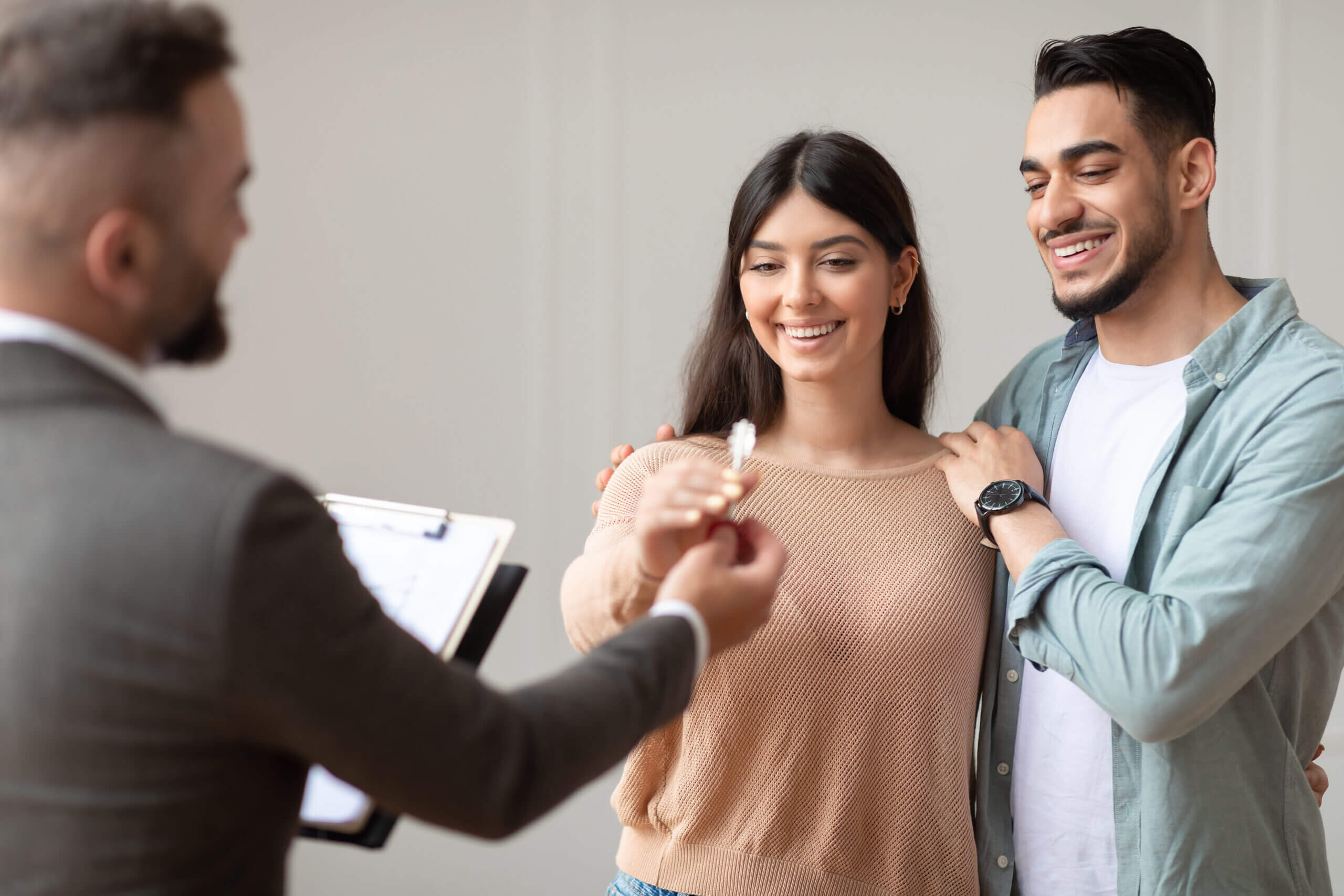 Real Estate Agent Giving Keys To Buyers